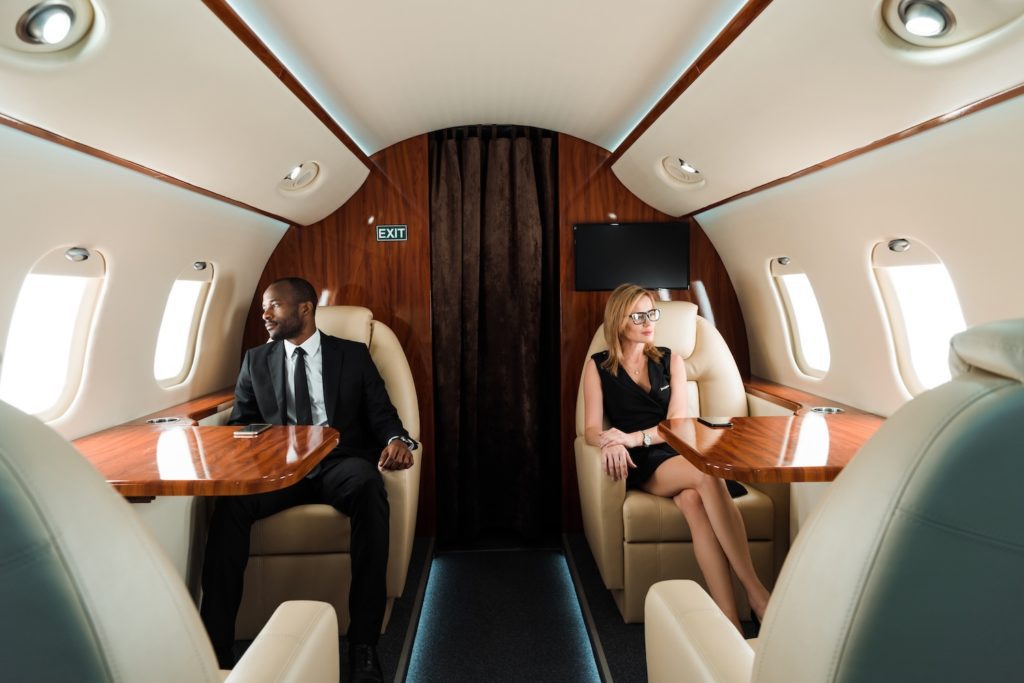 business people on private airplane