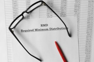 Paper with Required Minimum Distributions RMD on a table. Business concept