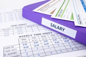 timesheet with salary notebook on table
