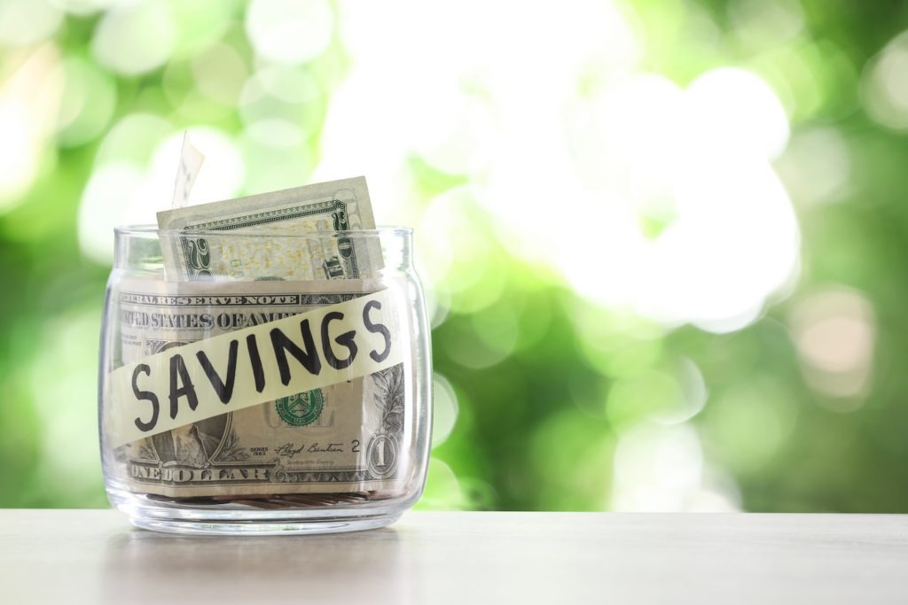 jar with savings on it and money inside of it