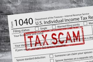 Tax Scam with 1040 tax form us individual income tax on a weathered wood desk