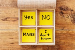 Checkbox. Close-up of wooden box with adhesive notes laying inside it