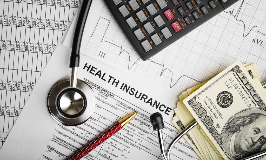 Health care costs. Stethoscope and calculator symbol for health care costs or medical insurance