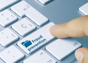 Fraud prevention Written on Blue Key of Metallic Keyboard.