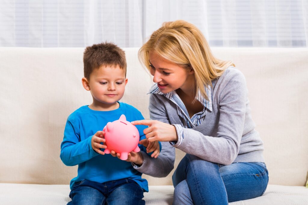 Mother and son with piggy bank